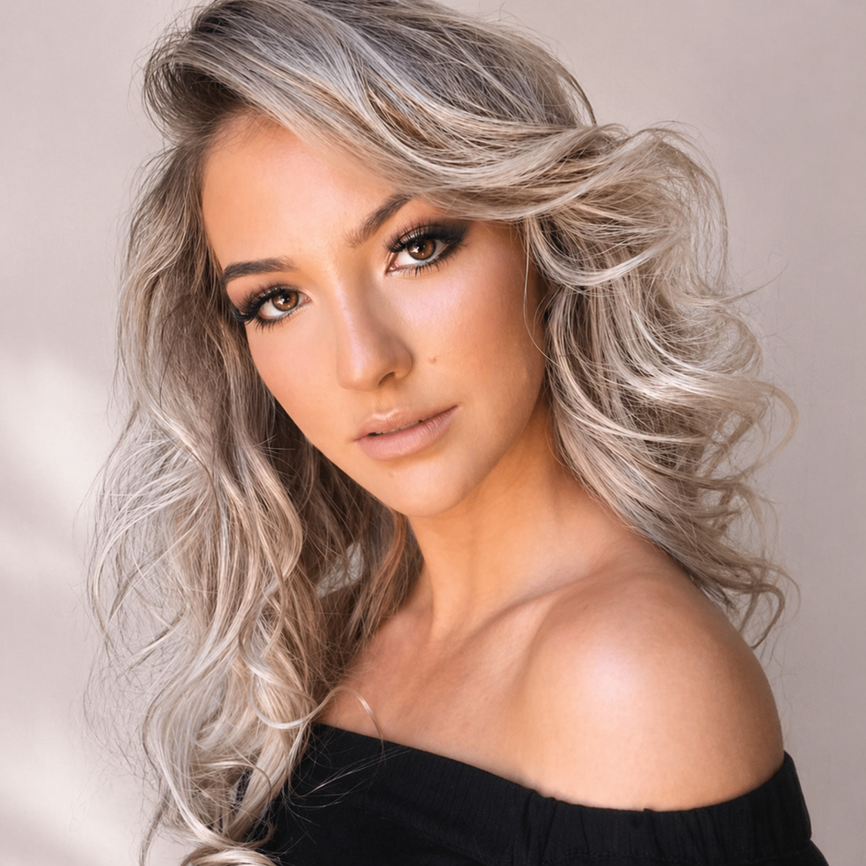 A client photographed after a Face Edit, soft glam, balanced contrast, calm confidence